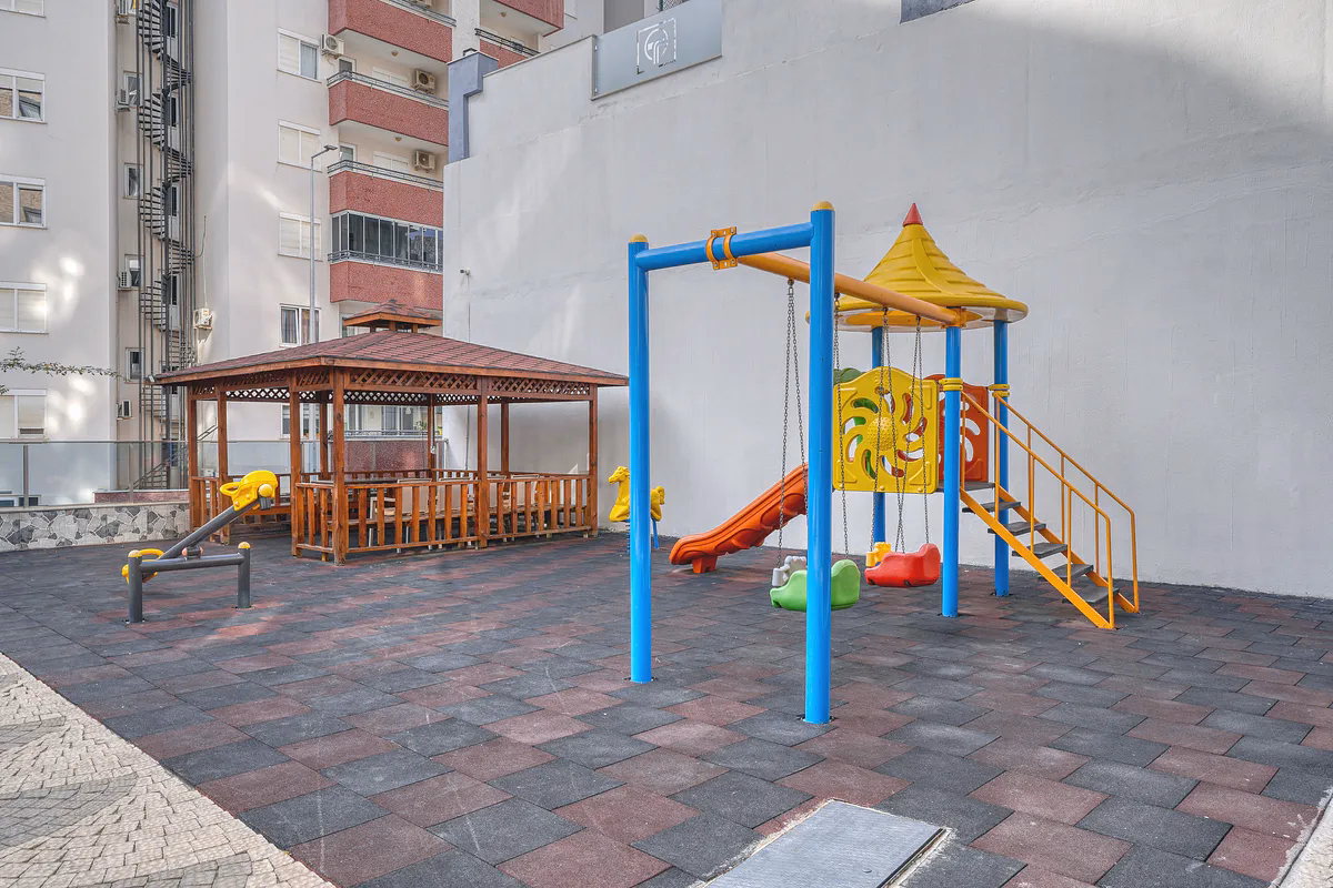 Buy Apartment Mahmutlar Alanya — Unfurnished 1+1 in Gökgür Palace (20) Children's playground area at Gökgür Palace Mahmutlar Alanya