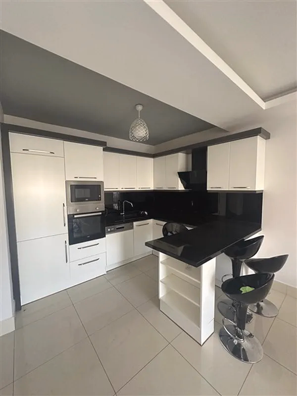 Buy Apartment in Alanya Turkey – Furnished 1+1 Apartment in Nordic Life Residence, Tosmur (15) Open-plan kitchen in Alanya investment apartment