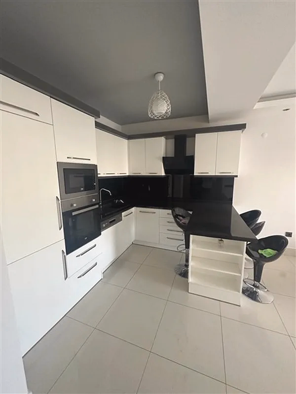Buy Apartment in Alanya Turkey – Furnished 1+1 Apartment in Nordic Life Residence, Tosmur (24) Open-plan kitchen in Alanya investment apartment