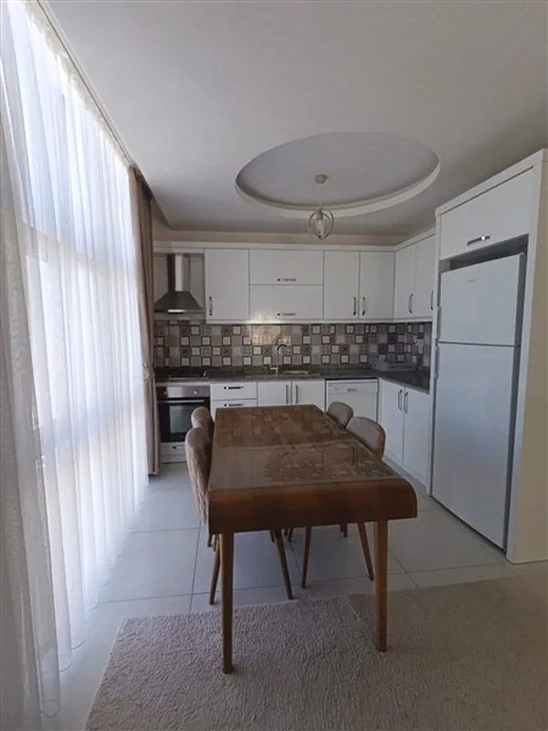 Furnished 2+1 Apartment in Mahmutlar (9) Open-plan kitchen in furnished apartment for sale in Mahmutlar Alanya